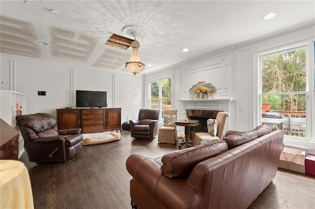 living area with a high end fireplace, a decorative wall, recessed lighting, and wood finished floors