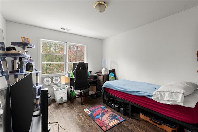 bedroom with visible vents and wood finished floors