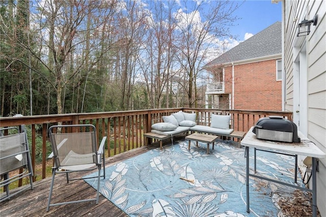 wooden terrace featuring an outdoor hangout area and a grill