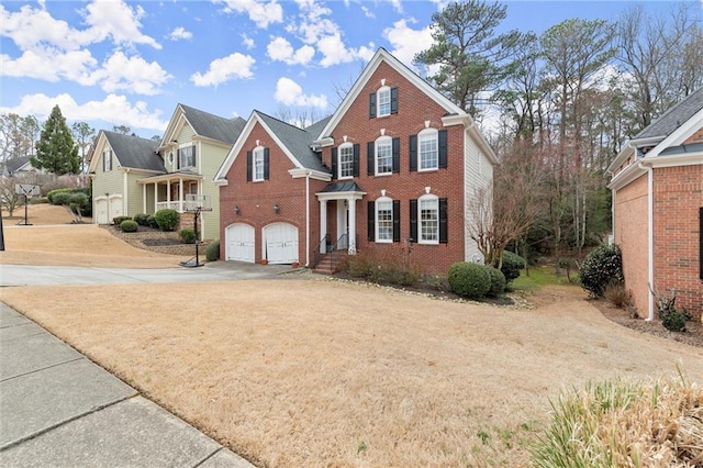 view of front of property with a garage, concrete driveway, and brick siding