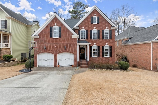 view of front facade featuring a garage, driveway, and brick siding