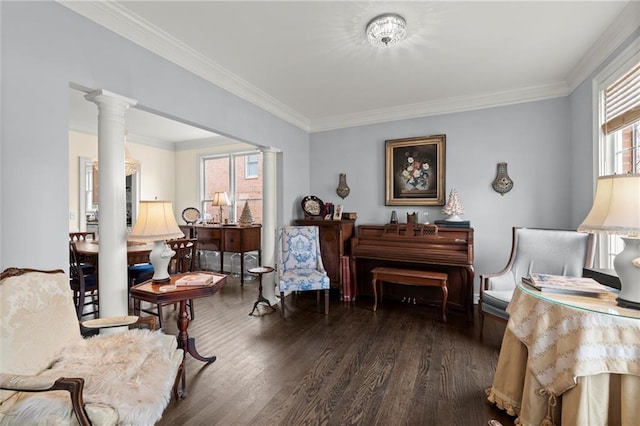 sitting room with decorative columns, ornamental molding, and dark wood-type flooring