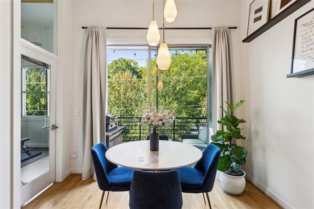 dining area featuring wood finished floors and baseboards