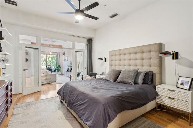 bedroom featuring light wood finished floors, visible vents, and access to exterior