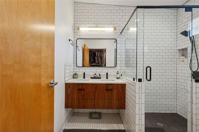 bathroom featuring decorative backsplash, a shower stall, vanity, and tile patterned floors