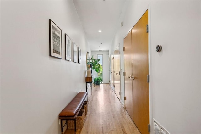 hallway with recessed lighting, visible vents, and light wood-type flooring