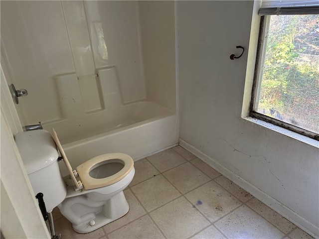 bathroom with tile patterned floors, shower / bathing tub combination, and toilet