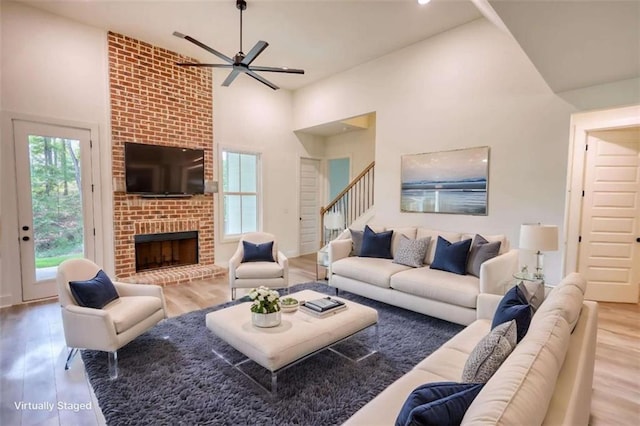 460 Ridge Point Dr, Monticello, GA 31064 - living room with a ceiling fan, wood finished floors, stairway, a brick fireplace, and recessed lighting