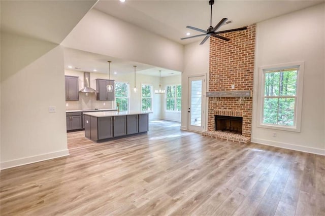 460 Ridge Point Dr, Monticello, GA 31064 - unfurnished living room with ceiling fan, light wood finished floors, recessed lighting, baseboards, and a fireplace