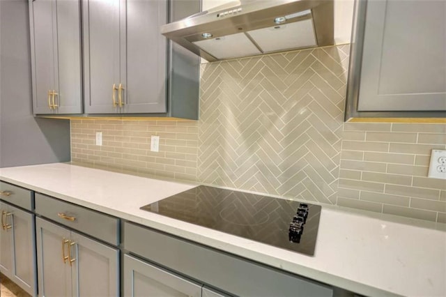460 Ridge Point Dr, Monticello, GA 31064 - kitchen featuring under cabinet range hood, gray cabinetry, backsplash, and black electric stovetop