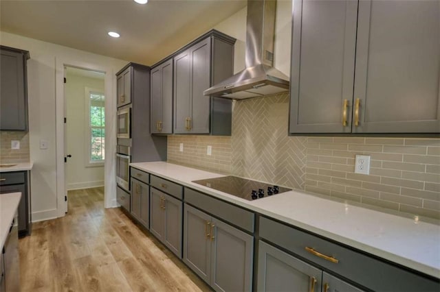 460 Ridge Point Dr, Monticello, GA 31064 - kitchen featuring wall chimney exhaust hood, black electric cooktop, oven, light wood finished floors, and backsplash