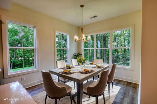 460 Ridge Point Dr, Monticello, GA 31064 - dining space featuring a chandelier, baseboards, and dark wood finished floors