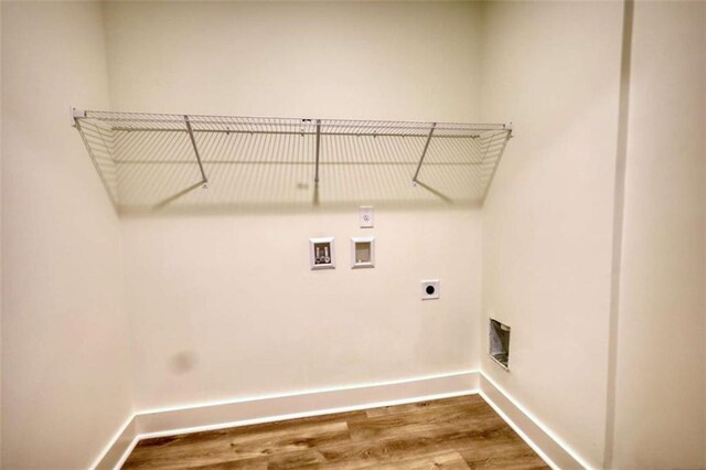 460 Ridge Point Dr, Monticello, GA 31064 - laundry room featuring hookup for an electric dryer, washer hookup, baseboards, and wood finished floors