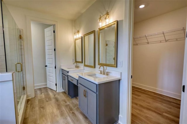 460 Ridge Point Dr, Monticello, GA 31064 - full bath with wood finished floors, a shower stall, vanity, a walk in closet, and recessed lighting