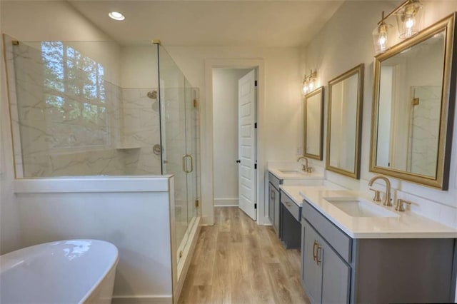 460 Ridge Point Dr, Monticello, GA 31064 - full bath with a marble finish shower, a freestanding bath, double vanity, wood finished floors, and recessed lighting
