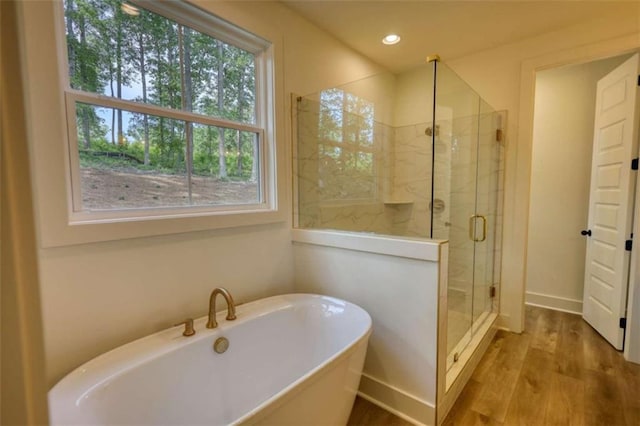 460 Ridge Point Dr, Monticello, GA 31064 - bathroom featuring a freestanding tub, wood finished floors, a shower stall, recessed lighting, and baseboards