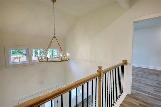 460 Ridge Point Dr, Monticello, GA 31064 - hall with a chandelier, an upstairs landing, wood finished floors, lofted ceiling, and baseboards