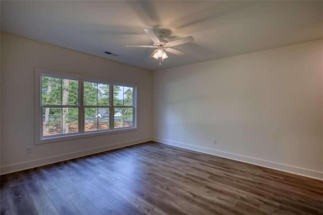 460 Ridge Point Dr, Monticello, GA 31064 - empty room with baseboards, dark wood-type flooring, and ceiling fan