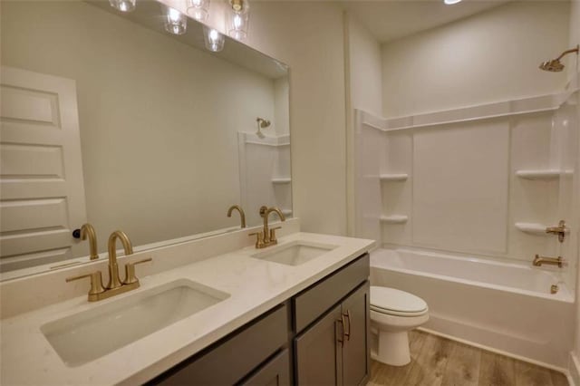 460 Ridge Point Dr, Monticello, GA 31064 - full bathroom featuring toilet, shower / bath combination, wood finished floors, and double vanity