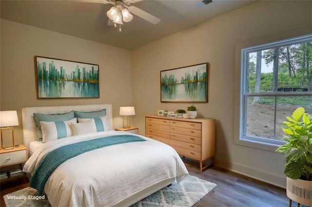 460 Ridge Point Dr, Monticello, GA 31064 - bedroom featuring wood finished floors, baseboards, multiple windows, and a ceiling fan
