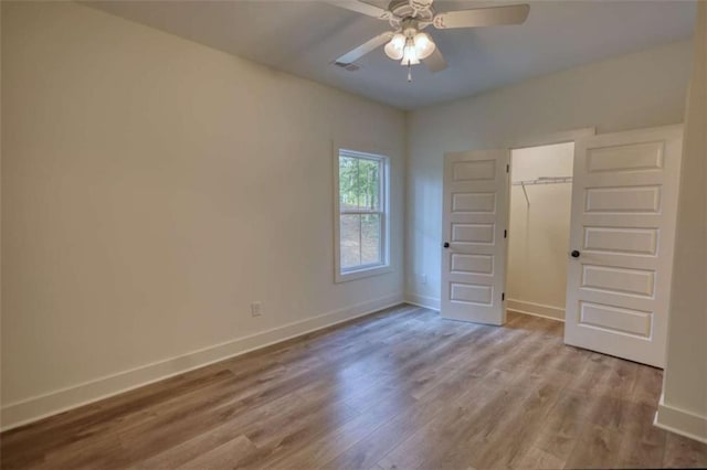 460 Ridge Point Dr, Monticello, GA 31064 - unfurnished bedroom with baseboards, wood finished floors, a closet, and ceiling fan