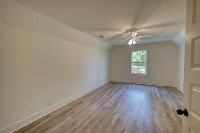 460 Ridge Point Dr, Monticello, GA 31064 - empty room featuring vaulted ceiling, ceiling fan, light wood finished floors, and baseboards