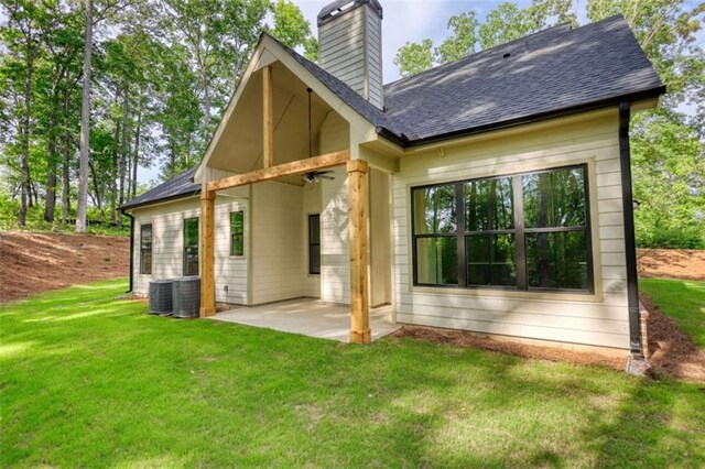 460 Ridge Point Dr, Monticello, GA 31064 - rear view of property featuring a patio area, a chimney, a yard, and roof with shingles