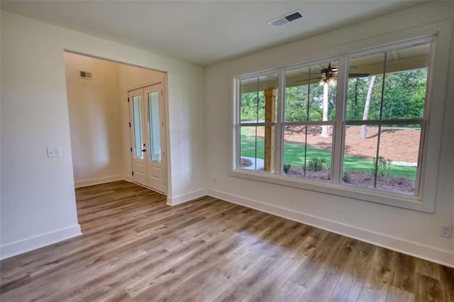 460 Ridge Point Dr, Monticello, GA 31064 - spare room with wood finished floors, baseboards, and a ceiling fan