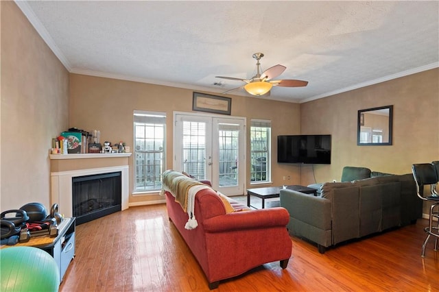 living room featuring ceiling fan, hardwood / wood-style floors, and ornamental molding