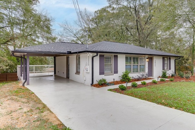 view of front facade with a front yard and a carport