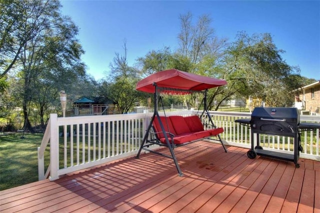 deck with grilling area and a yard