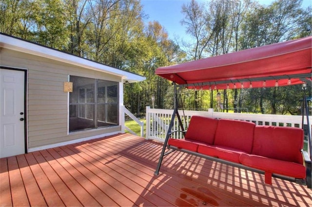 deck with outdoor lounge area and a sunroom