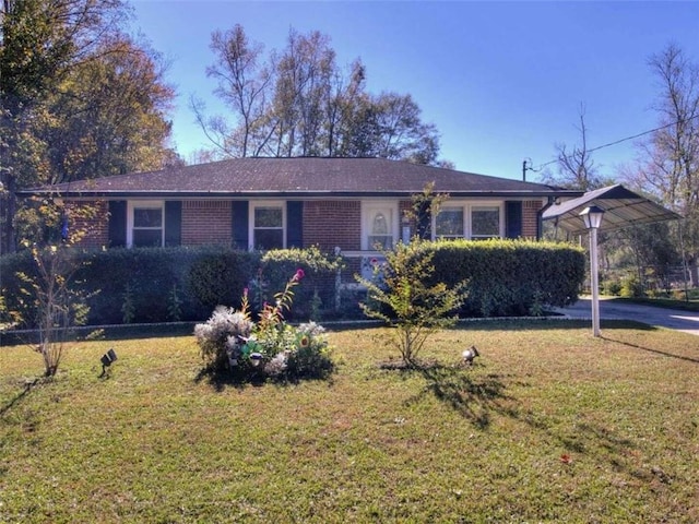 ranch-style home with a front yard and a carport