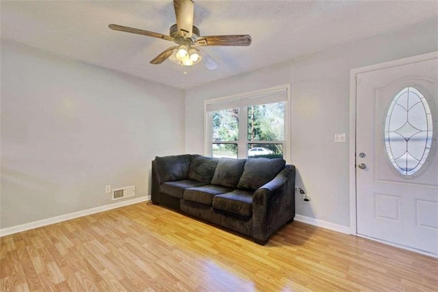 living room with ceiling fan and light hardwood / wood-style floors