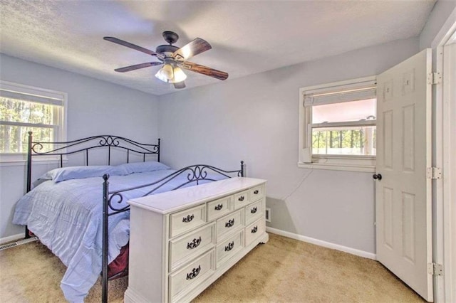 bedroom featuring ceiling fan and light carpet