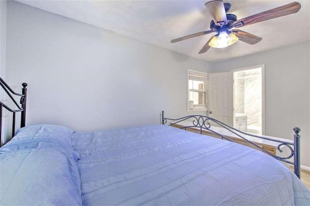 bedroom featuring ensuite bath and ceiling fan