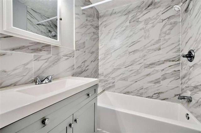 bathroom featuring vanity, tile walls, and tiled shower / bath