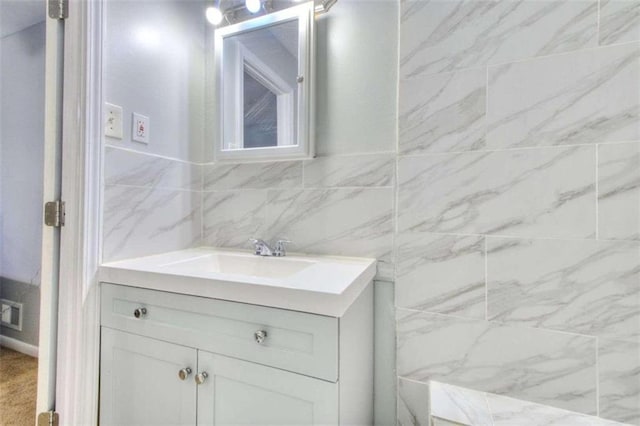 bathroom with vanity and tile walls