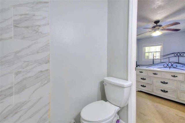 bathroom featuring ceiling fan and toilet