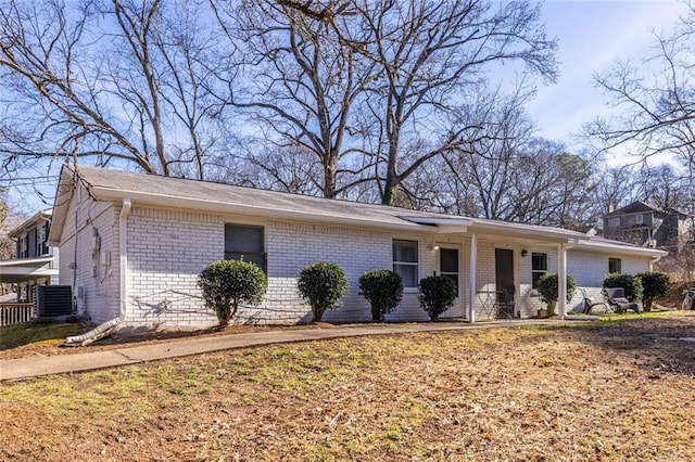 ranch-style home featuring central AC unit