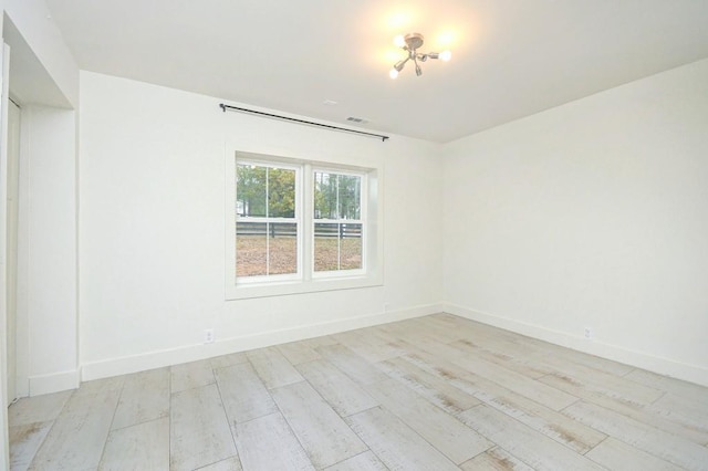 unfurnished room with light wood-type flooring