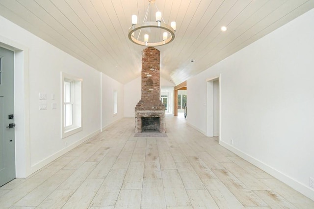 unfurnished living room featuring plenty of natural light, wood ceiling, lofted ceiling, and light hardwood / wood-style flooring