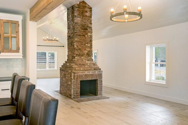 living room featuring plenty of natural light, a chandelier, and light wood-type flooring