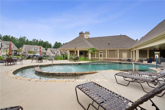 view of pool with pool water feature and a patio