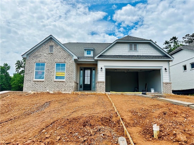 7040 Manchester Dr, Flowery Branch, GA 30542 - craftsman inspired home with brick siding, an attached garage, and roof with shingles