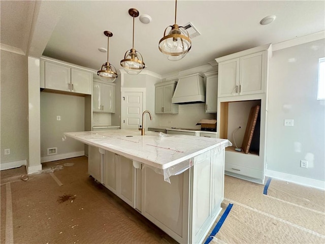 7040 Manchester Dr, Flowery Branch, GA 30542 - kitchen featuring custom range hood, a sink, baseboards, a spacious island, and light stone counters