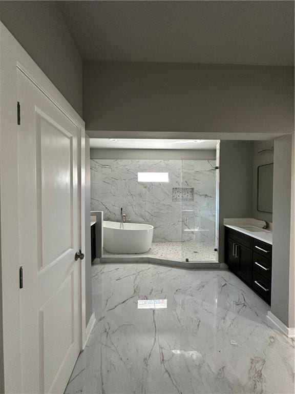 bathroom with vanity and a tub