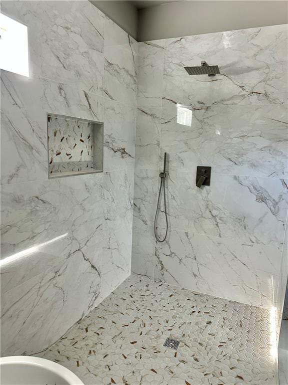 bathroom featuring tiled shower