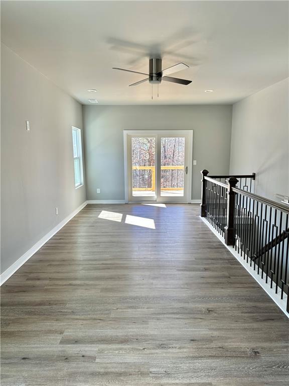 unfurnished room featuring ceiling fan and dark hardwood / wood-style flooring