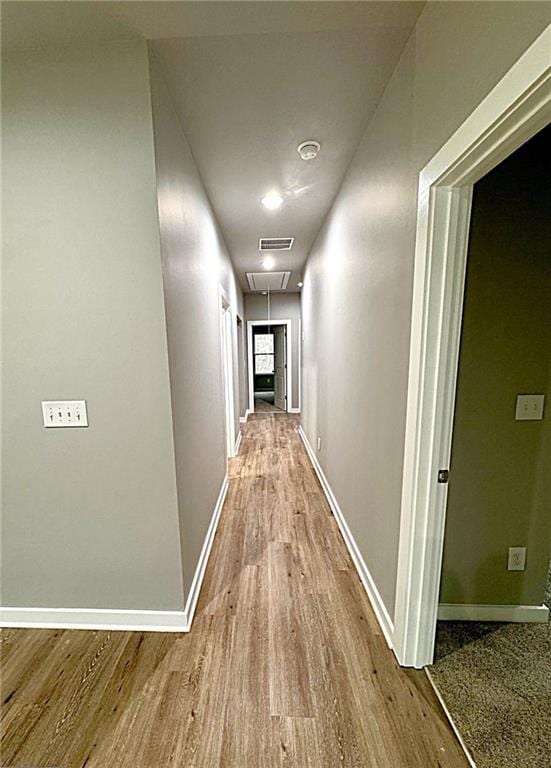 corridor with light hardwood / wood-style flooring